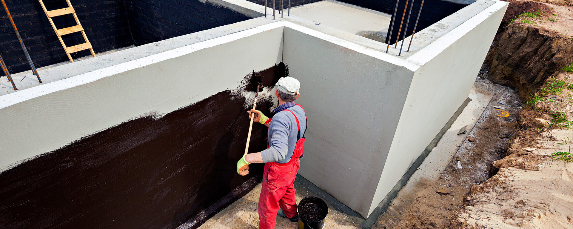 person installing foundational waterproofing