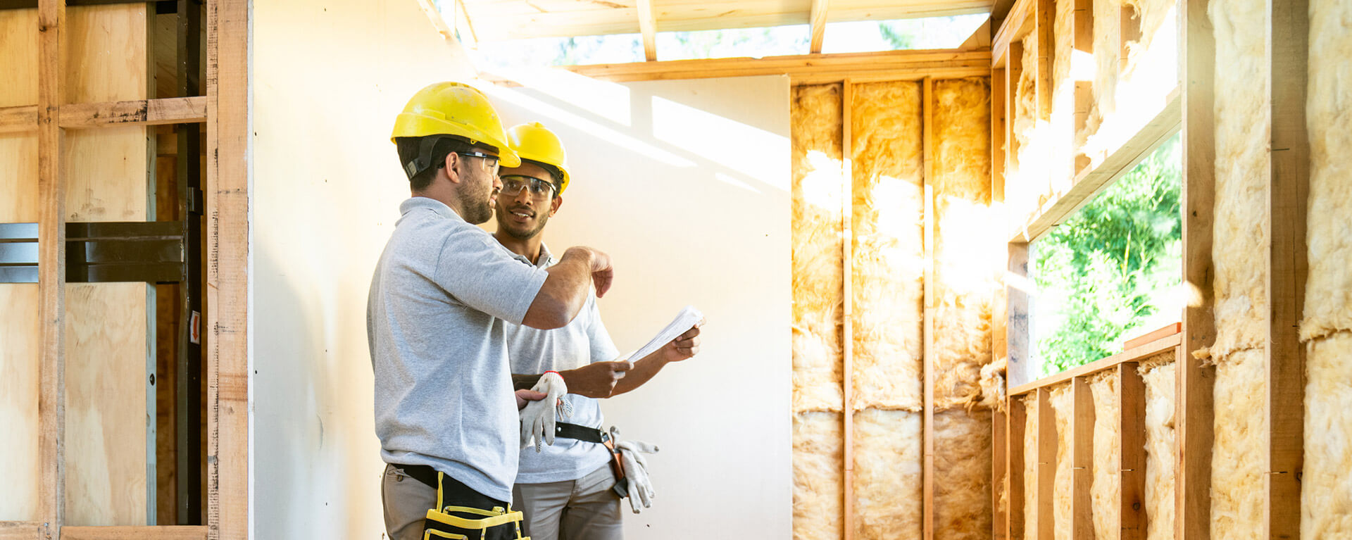 two contractors talking in an unfinished building